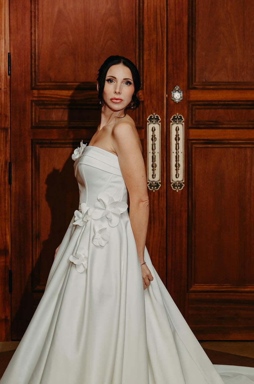 Model wearing a bridal dress near the door
